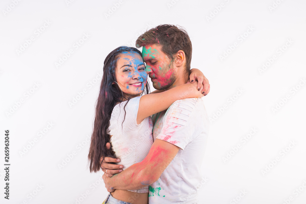 Festival of holi, friendship - young people playing with colors at the festival of holi on white background Festival of holi, friendship - young people playing with colors at the festival of holi on white background