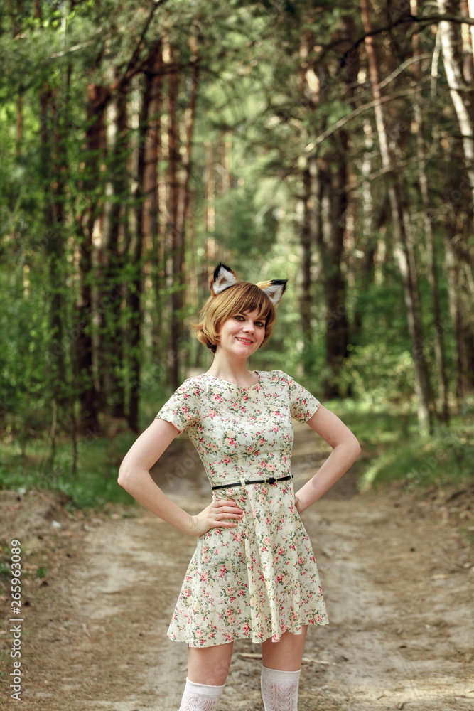 Woman with fox ears against the background of a pinewood Woman with fox ears against the background of a pinewood