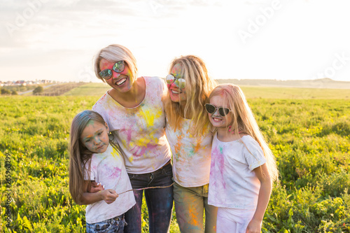 Festival of holi, people concept - Group of young people having fun outdoors