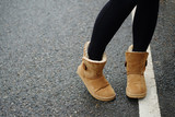 Photo of girls foot at cold day in warm clothes