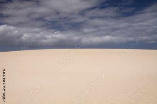 Bright shining white edge of sand dune contrasting against deep blue sky, Corralejo, Fuerteventura, Canary Islands