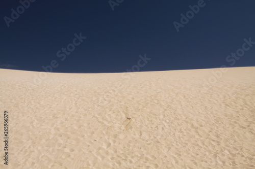 Bright shining white edge of sand dune contrasting against deep blue sky, Corralejo, Fuerteventura, Canary Islands