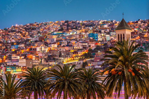 Colorful houses illuminated at night on a hill of Valparaiso, Chile photo