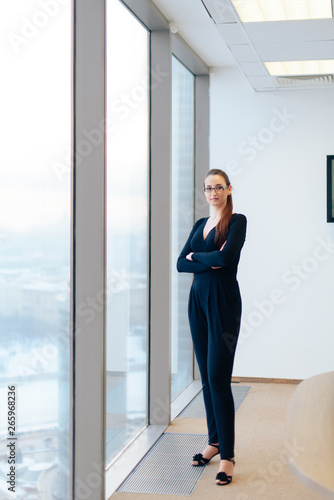 beautiful girl business lady in her office in a skyscraper