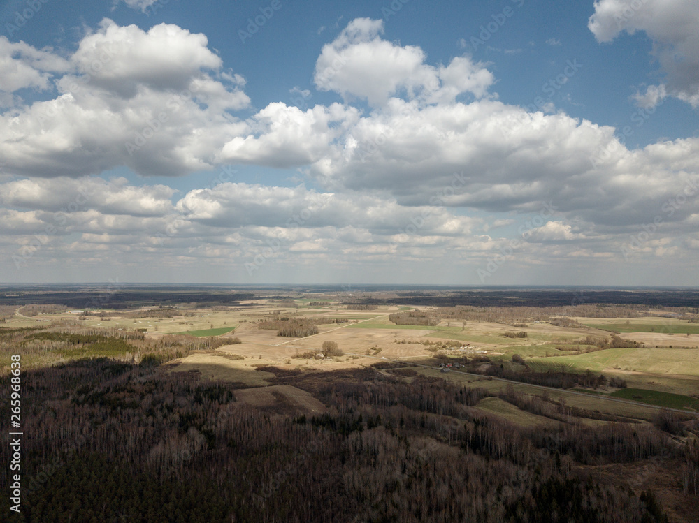 aerial view of countryside fields and forests with small lakes aerial view of countryside fields and forests with small lakes
