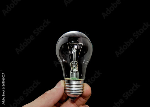 bulb hold fingers on black background