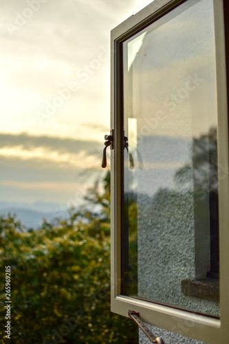 View of out of window of beautiful landscape, ominous sky and mountains in the background. Windermere, Lake District, Cumbria, UK -Image