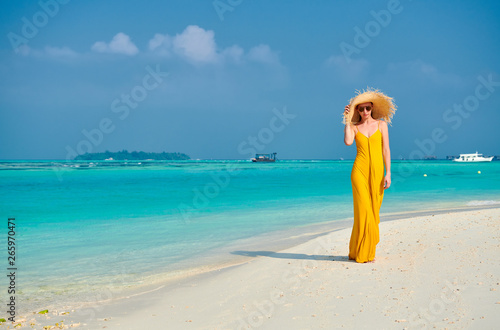 Woman in dress walking on tropical beach © haveseen