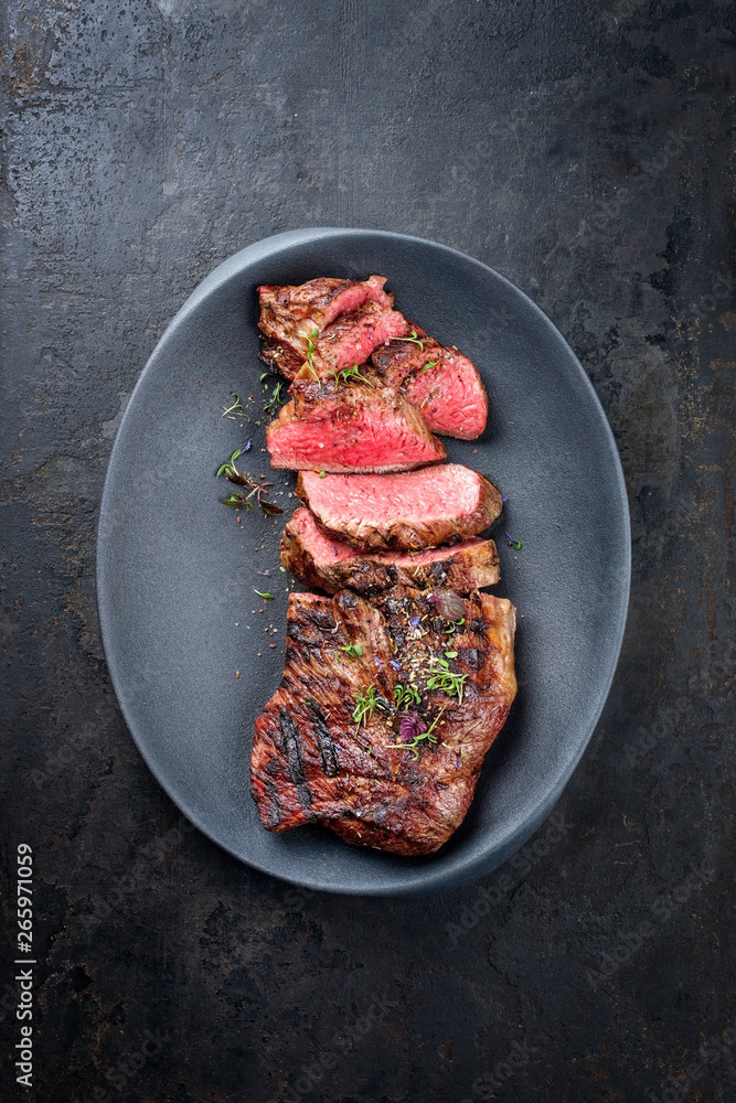 Barbecue dry aged wagyu tri tip steak sliced as top view in a