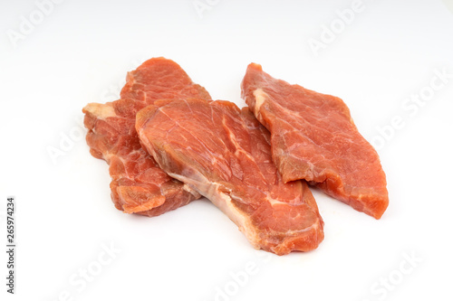 Fresh raw beef meat slices isolated over white background. Selective focus