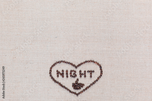 Night in heart sign from coffee beans isolated on linea texture, aligned bottom center.