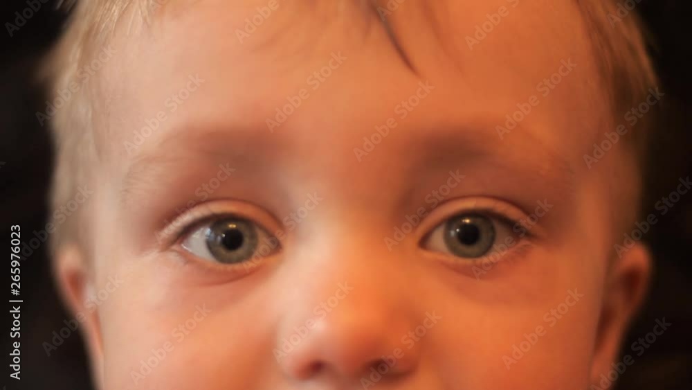 eyes close-up portrait of an adorable baby boy who looks into camera and around himself in slow motion 4K background video. eyes close-up portrait of an adorable baby boy who looks into camera and around himself in slow motion 4K background video.