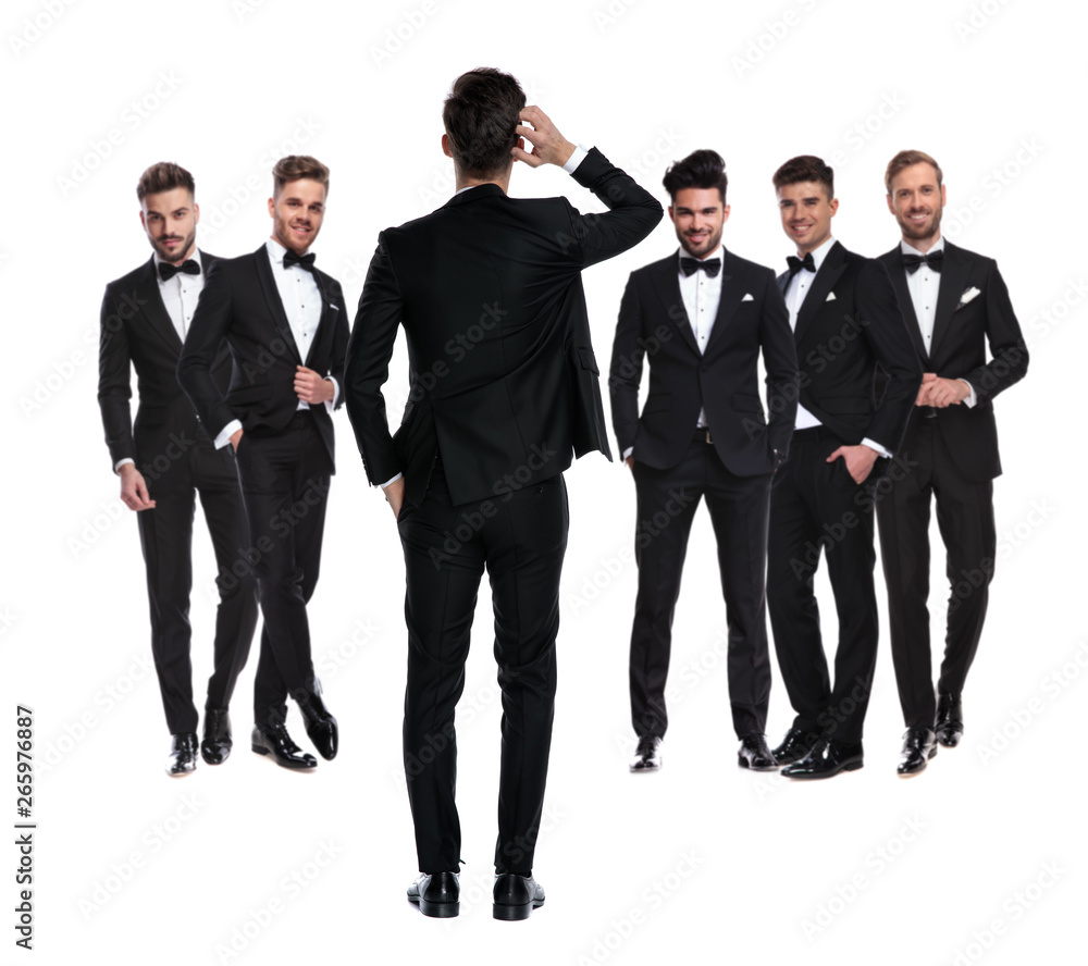 confused groom scratching head while standing in front of team confused groom scratching head while standing in front of team
