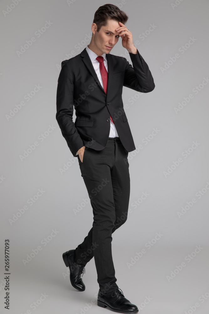handsome man stepping and thinking with hand in pocket handsome man stepping and thinking with hand in pocket