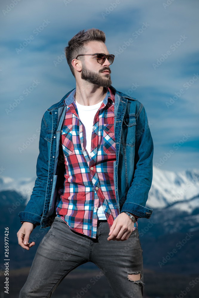 portrait of a young bearded man looking to side portrait of a young bearded man looking to side