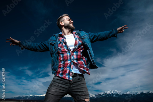 happy young casual man in a fly pose is dreaming