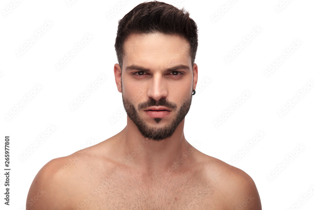 attractive topless guy with beard looking angry