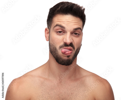 Canvas Print displeased undressed man being goofy with tongue out