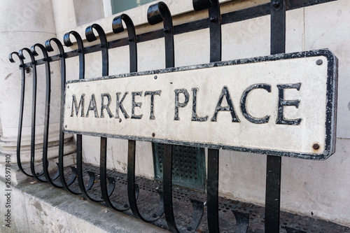 market place sign on an iron fence