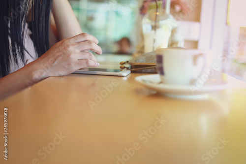 female using mobile phone in coffee cafe