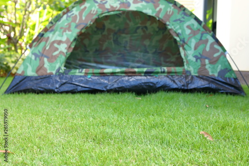 tent camping on green grass lawn campsite, equipment for trip backpack journey travel in nature