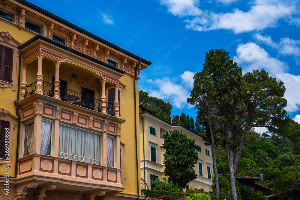 Naklejka premium Cityscape of italian coastal town on Ligurian riviera from the top, Italy. The incredibly beautiful Italian coastal town of Portofino with colorful houses and villas, luxury yachts in harbor.