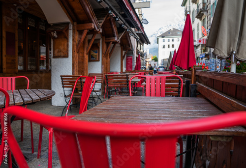 View of old street in Chamonix village, France. Cozy cityscape.Typical view of the street with tables of cafe in Chamonix.