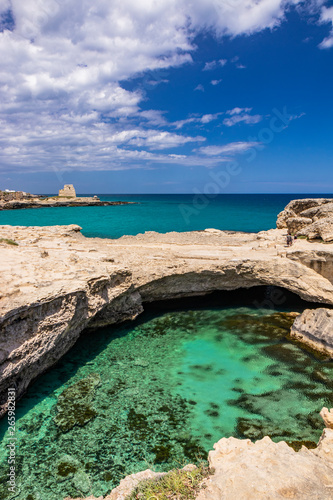Archaeological site and tourist resort of Roca Vecchia, Puglia, Salento, Italy. Turquoise sea, clear blue sky, rocks, sun, in summer. The Cave of Poetry. The lookout tower in the background. © Ragemax