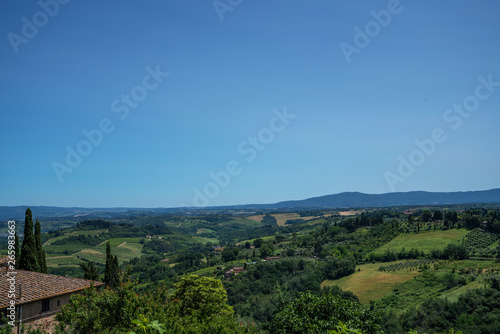 Chianti region in summer season. View of countryside and Chianti vineyards from San Gimignano. Tuscany  Italy  Europe. Travel. Beautiful destination. Holiday outdoor vacation trip.