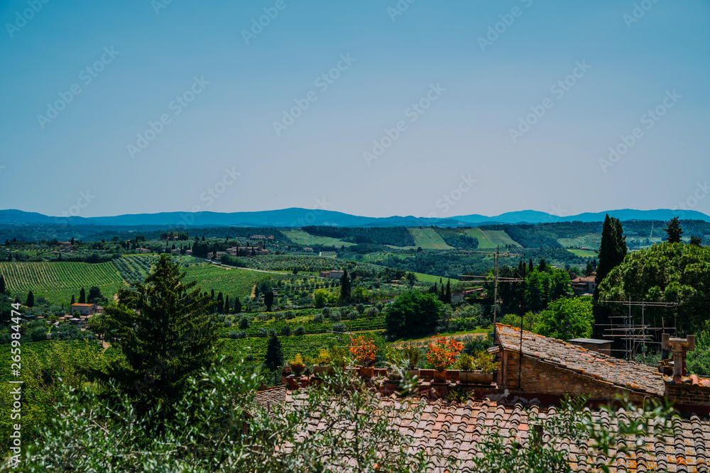 Chianti region in summer season. View of countryside and Chianti vineyards from San Gimignano. Tuscany, Italy, Europe. Travel. Beautiful destination. Holiday outdoor vacation trip.