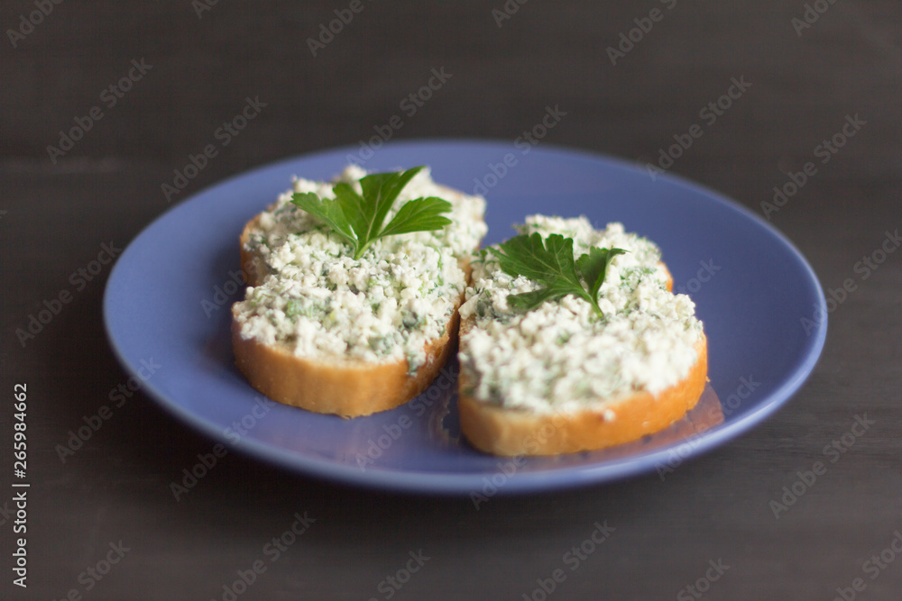 sandwiches with cottage cheese and herbs on a dark background, healthy and low-calorie snack between main meals