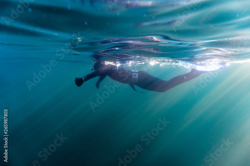 Freediver preparing for a dive in the blue cold atlantic on the shores of Norway. © Snorre