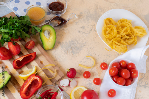 raw spaghetti and ingredients for cooking pasta on the tables, differrent sauces, italian restaurant foods