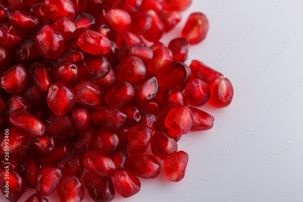 grains of a grenade on a white acrylic background grains of a grenade on a white acrylic background