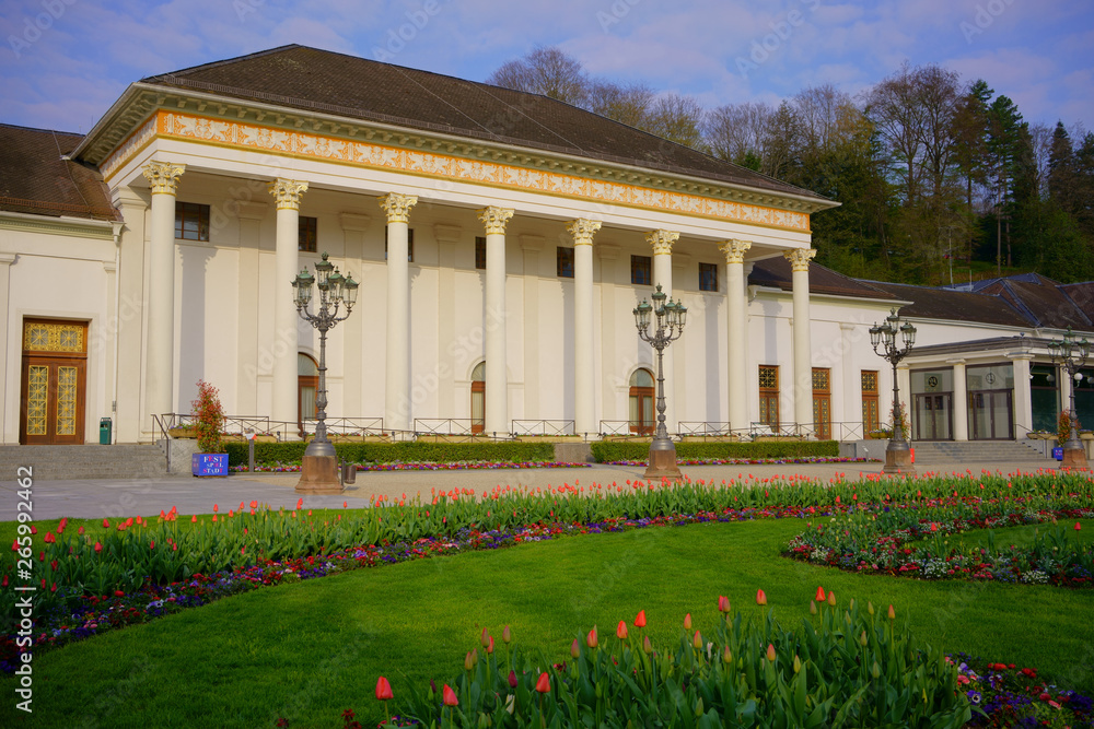 The Kurhaus and Casino in Baden-Baden, Baden-Württemberg, Germany. Elegance of Belle Epoque style architecture in the historic heart of Baden-Baden. Beautiful sunlit April flowers in front, no people.