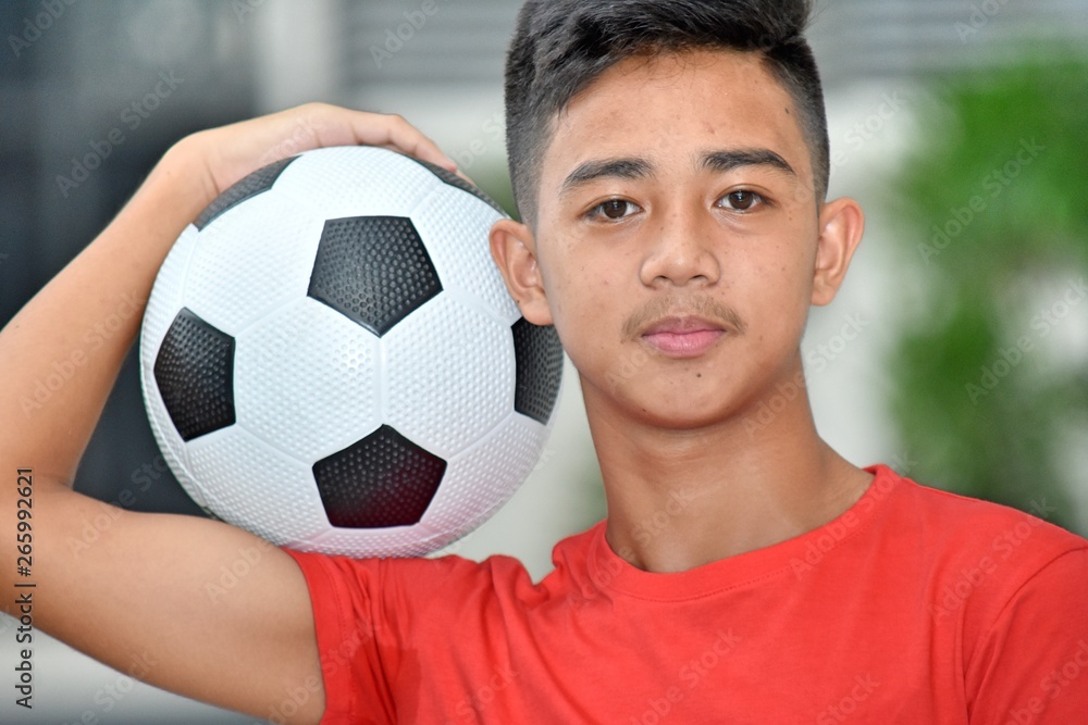 Unemotional Male Athlete With Soccer Ball