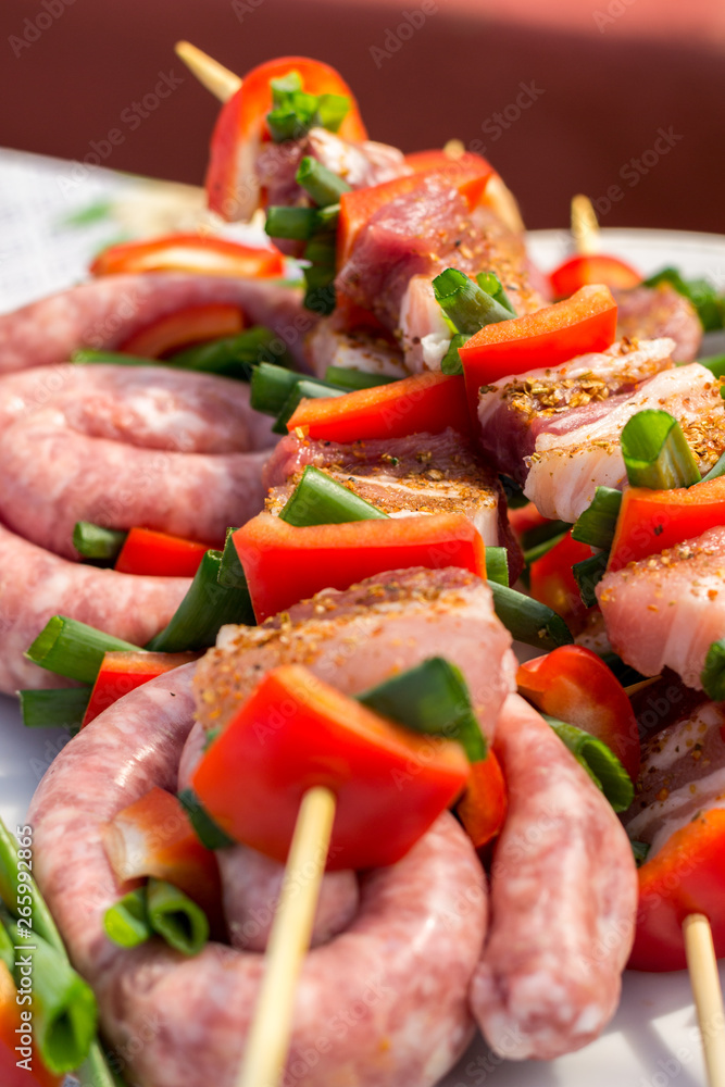 Close up pf delicious chicken breast on wooden skew with fresh vegetables, garlic, paprika fried on mangal barbeque grill and smoke Close up pf delicious chicken breast on wooden skew with fresh vegetables, garlic, paprika fried on mangal barbeque grill and smoke