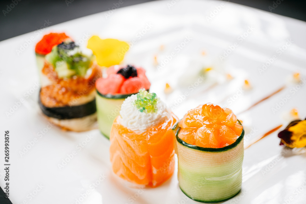 Plate with five different sushi rolls. Degustation, gastronomy, seafood Japanese food art, restaurant menu concept, deluxe chef cuisine