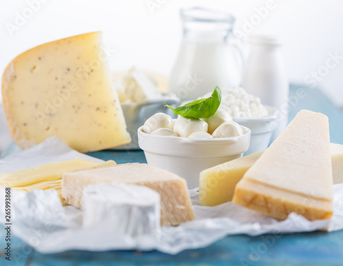 Different types of dairy products on wooden background photo