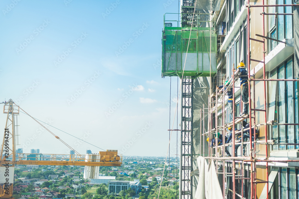 Construction site background. Hoisting cranes and new multi-storey buildings.