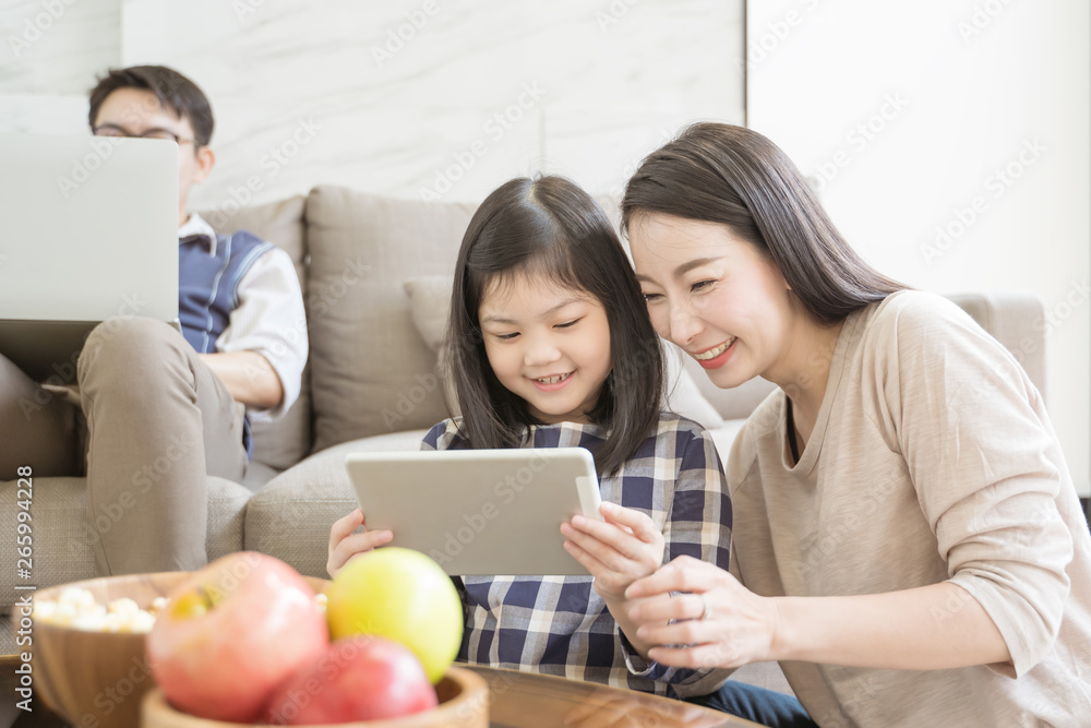 happy asian family spending time together on sofa in living room. family and home concept happy asian family spending time together on sofa in living room. family and home concept
