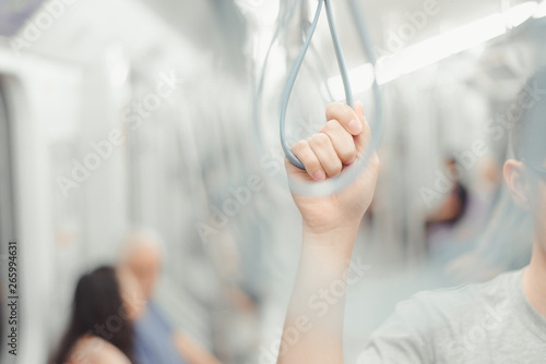 City living concept male hand holding a looped handle in urban public transportation © grooveriderz
