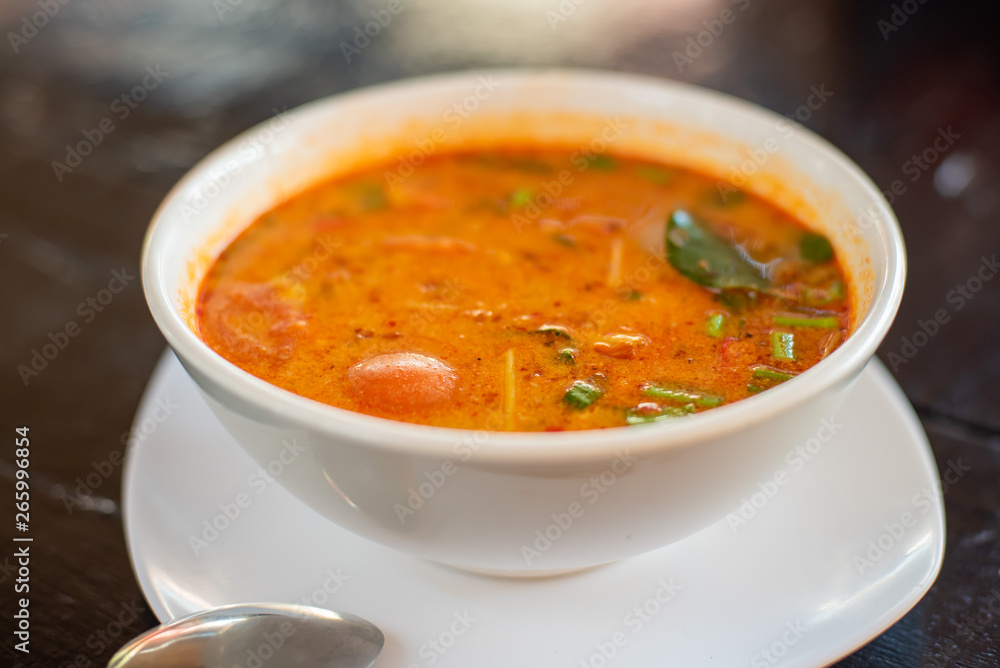 Tom Yam kung Spicy Thai soup with shrimp, seafood, coconut milk and chili pepper in bowl copy space Tom Yam kung Spicy Thai soup with shrimp, seafood, coconut milk and chili pepper in bowl copy space