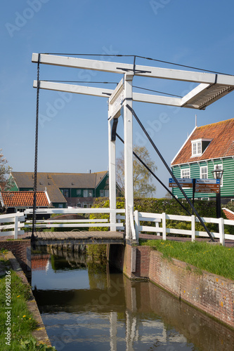 Wilhelmina drawbridge over a canal water in the picturesque village of Marken in Waterland