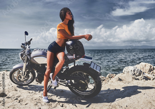 Obraz na płótnie sexy asian woman near her vintage custom motorcycle w salonie