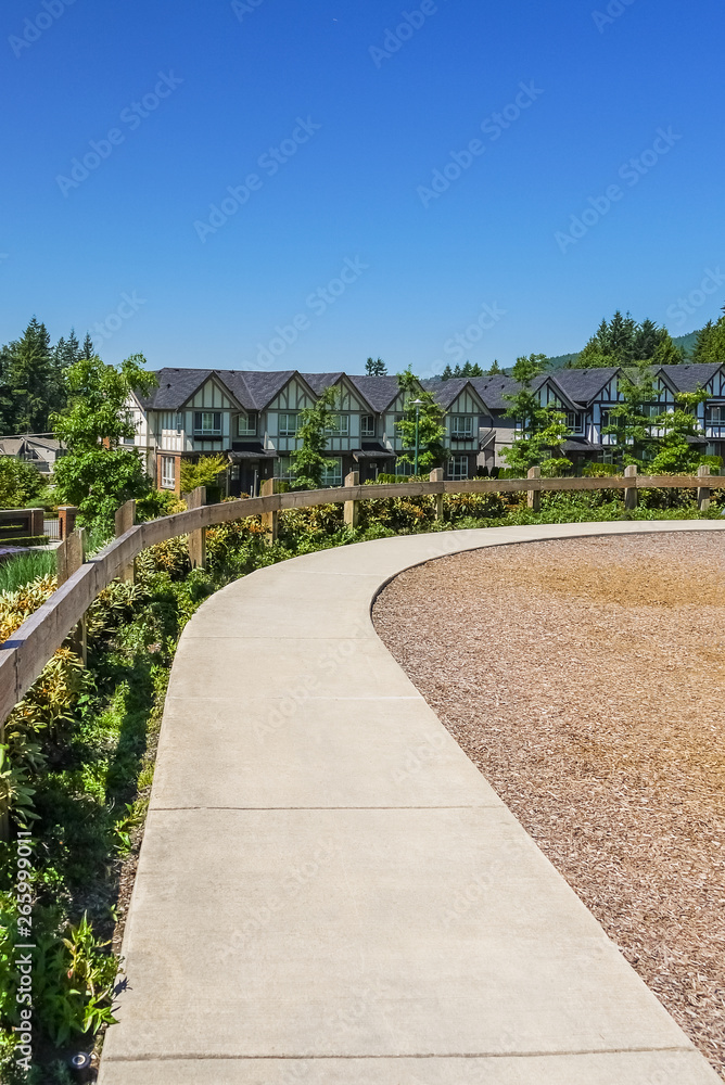 Convenient concrete walkway along the row of new townhouses