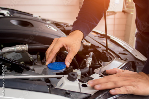 Mechanic working on engine in garade