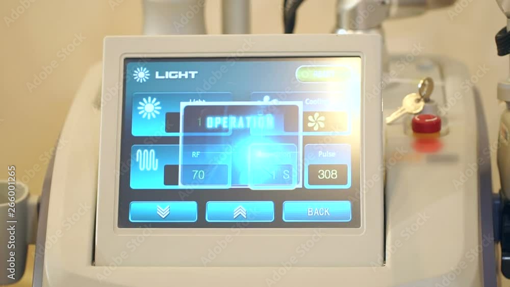 Cosmetologist includes modes of operation on the screen of radio wave lifting. Close-up of the cosmetology equipment screen. Close-up of medical equipment in spa salon. Cosmetologist includes modes of operation on the screen of radio wave lifting. Close-up of the cosmetology equipment screen. Close-up of medical equipment in spa salon.