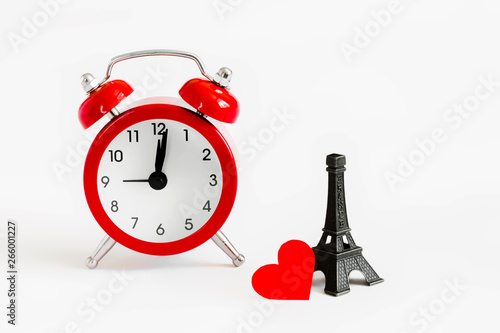 Romantic trip to Paris concept. Honeymoon, time to fall in love. Invitation to a romantic trip, a love note. Eiffel tower with red alarm clock photo