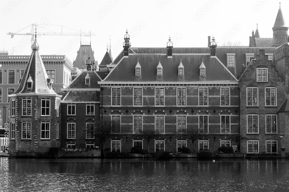 View of the Hofvijver / Court Pond adjoined by museum Mauritshuis and the Binnenhof (Inner court) housing the States General and the Prime Minister of The Netherlands in The Hague, The Netherlands. 